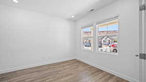 Spare room featuring wood finished floors and recessed lighting