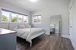 Bedroom featuring wood finished floors and a textured ceiling