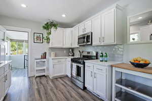 Kitchen with appliances with stainless steel finishes, light countertops, decorative backsplash, and recessed lighting