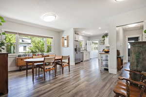 Dining room with wood finished floors and recessed lighting