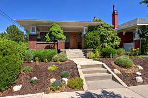 View of front of home with brick siding and covered porch