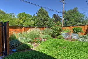 Fenced backyard with a garden
