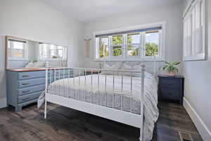Bedroom featuring dark wood-style flooring