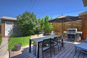 Wooden terrace with outdoor dining space and grilling area