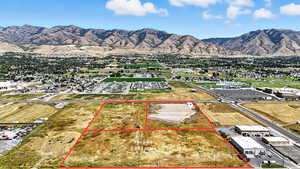 Aerial overview of property's location with a mountainous background and property parcel outlined