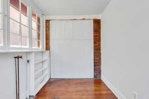Spare room featuring wood-type flooring and baseboards