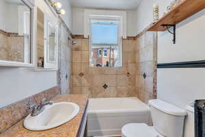 Bathroom with vanity and shower / tub combination
