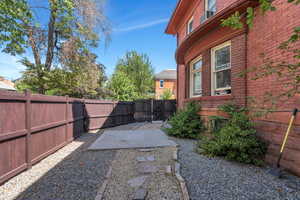 Fenced backyard featuring a patio and a gate
