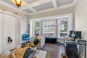 Sitting room featuring plenty of natural light, coffered ceiling, hardwood / wood-style flooring, beam ceiling, and radiator