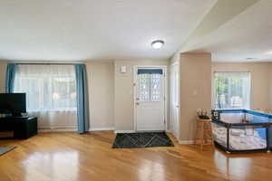 Foyer featuring hardwood / wood-style floors and a textured ceiling
