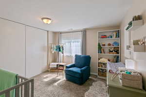 Bedroom with carpet floors and a textured ceiling