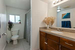 Full bathroom featuring vanity, tile patterned floors, and a textured ceiling