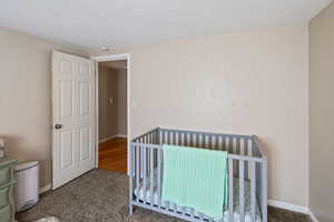 Bedroom featuring carpet floors and a textured ceiling