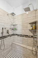 Bathroom featuring tiled shower