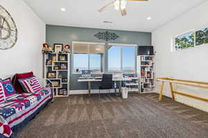 Carpeted office featuring a ceiling fan and recessed lighting