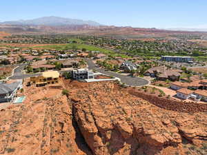 Aerial view of property's location featuring nearby suburban area and mountains