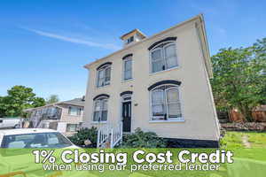 Italianate home featuring brick siding