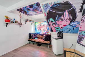 Living area with wood finished floors and baseboards