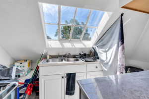 Kitchen with healthy amount of natural light and white cabinetry
