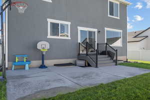 Back of property with stucco siding and a patio