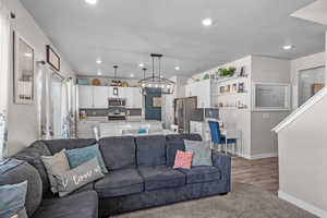 Living area featuring recessed lighting, wood finished floors, and a chandelier
