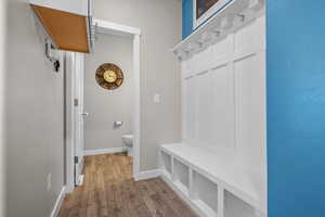Mudroom with wood finished floors and baseboards