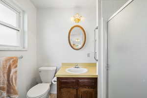Full bath with vanity and a shower with shower door