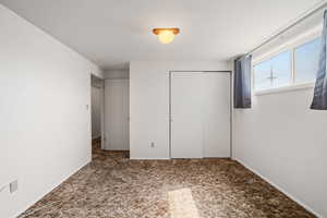 Unfurnished bedroom with a closet and carpet