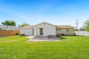 Rear view of house with a patio area and a fenced backyard