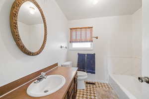 Full bath featuring a bathtub and vanity