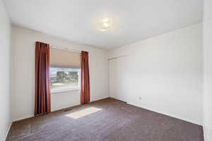 Unfurnished room featuring carpet flooring and baseboards