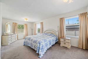 Bedroom featuring light colored carpet and baseboards