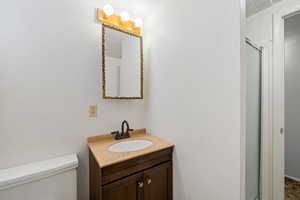 Full bath featuring vanity and a shower with shower door