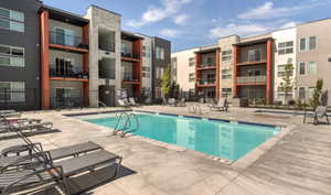 Community pool with a patio