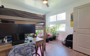 Office space with wood finished floors, a textured ceiling, and ceiling fan