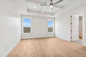 Spare room with light wood-style floors, beam ceiling, recessed lighting, a ceiling fan, and coffered ceiling