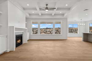 Unfurnished living room with beamed ceiling, coffered ceiling, recessed lighting, light wood-style floors, and a ceiling fan