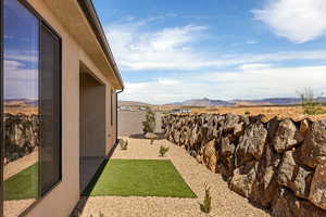 Fenced yard featuring a mountain view