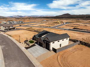 Aerial perspective of suburban area with a mountain backdrop and a desert landscape