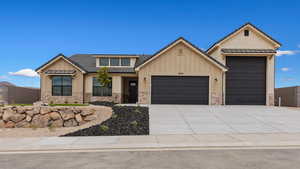 View of front facade featuring a garage, board and batten siding, driveway, and brick siding