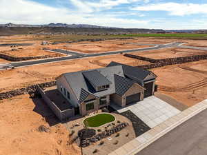 Aerial view of sparsely populated area with a mountain backdrop and a desert landscape