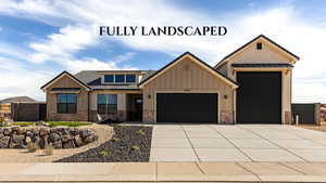 View of front of property with board and batten siding, an attached garage, brick siding, and driveway