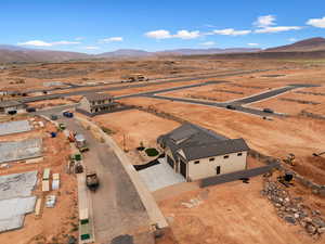 Aerial view of sparsely populated area with a desert landscape and a mountainous background