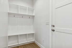 Mudroom featuring wood finished floors and baseboards