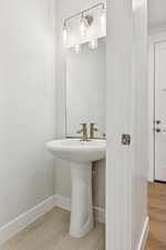 Bathroom featuring baseboards and a sink