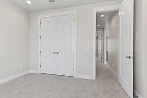 Unfurnished bedroom featuring recessed lighting, carpet, and a closet