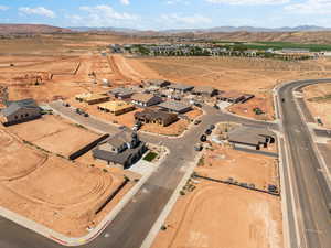 Aerial view of property and surrounding area with a mountain backdrop, nearby suburban area, and rural landscape