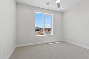 Carpeted empty room featuring a ceiling fan and recessed lighting