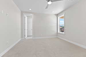 Unfurnished room with light colored carpet, ceiling fan, and recessed lighting
