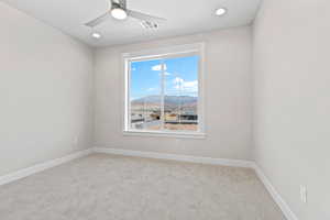 Carpeted spare room with recessed lighting, a mountain view, and a ceiling fan